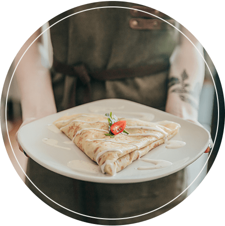 Image: Barista holds out gourmet savory crepe